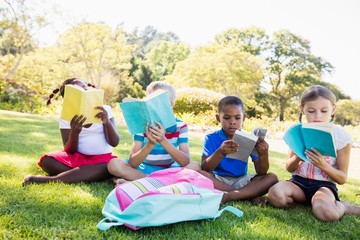 Kids reading books during a sunny day