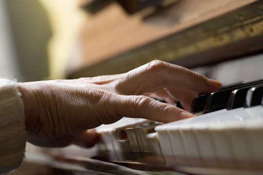 Piano chord pressed by woman's hand