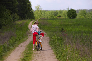 Fototapeta premium Portrait of a girl with a bycicle