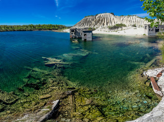 Abandoned mines and hauses. Quarry and old prison architecture. Crystal clear blue water, lake and mountain. The ashes dunes in  Estonia, Europe.