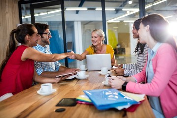 Casual business team giving handshake