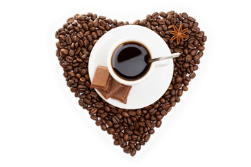 white cup of coffee on  beans as a heart