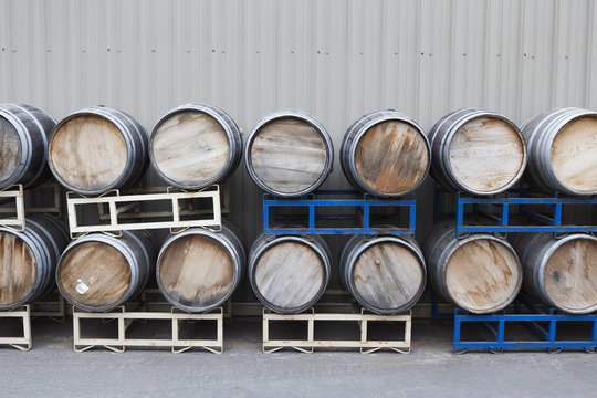 Barrels of wine stacked in a winery