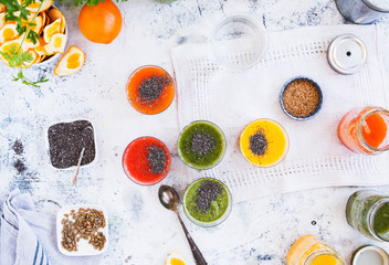 Overhead of variety fruits smoothies glass jars with chia and sesame seeds. Detox and diet concept.