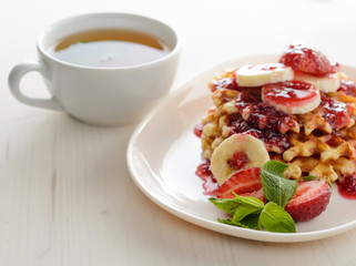belgium waffles with strawberries, mint and raspberry jam
