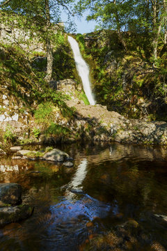 Linhope Spout, waterfall. Northumberland, England, Uk. In the early morning sunlight and shadow