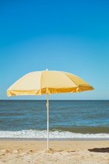 Sun parasol on the sandy beach ocean sky