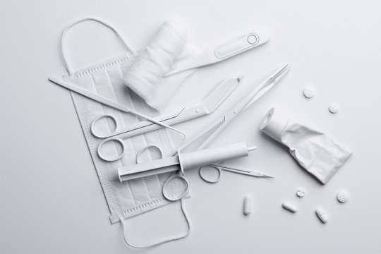 Medicine and medical equipment painted white and scattered on a white surface