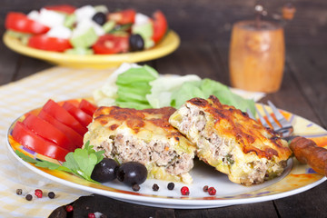 Portion of delicious Greek moussaka with minced meat on rustic table
