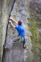 A rock climber climbs up the mountain.
