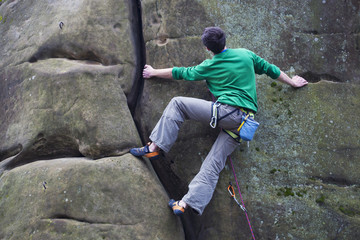 A rock climber climbs up the mountain.