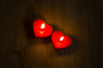 Two candles for love shining in the dark.