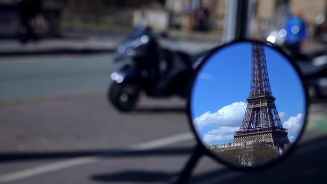 The Eiffel Tower is in a small mirror
