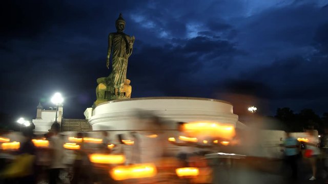 4K: People walk with candles around a large Buddha statue to celebrate Visakha Bucha Day