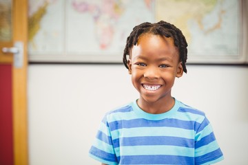 Fototapeta premium Portrait of smiling schoolboy in classroom