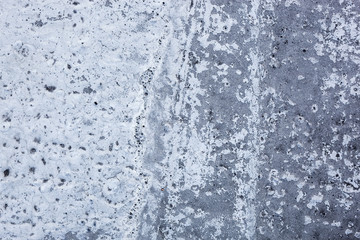 Partly whitewashed concrete wall with rich and various texture