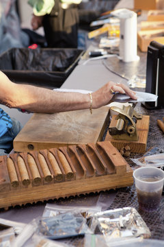Man using tools in cigar making factory