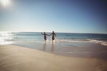 Couple running on beach