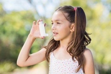 Girl using an asthma inhaler