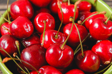 Cherries in the Cup on Wooden Table