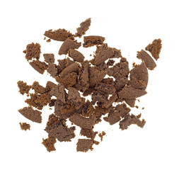 Top view of crumbled Dutch cocoa cookies on a white background.