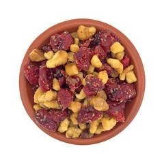 Top view of cranberries and walnuts in a small bowl isolated on a white background.