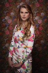 Beautiful sensuality girl on a flower wall background
