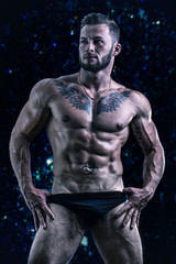 Fototapeta na wymiar Muscular young man standing shirtless