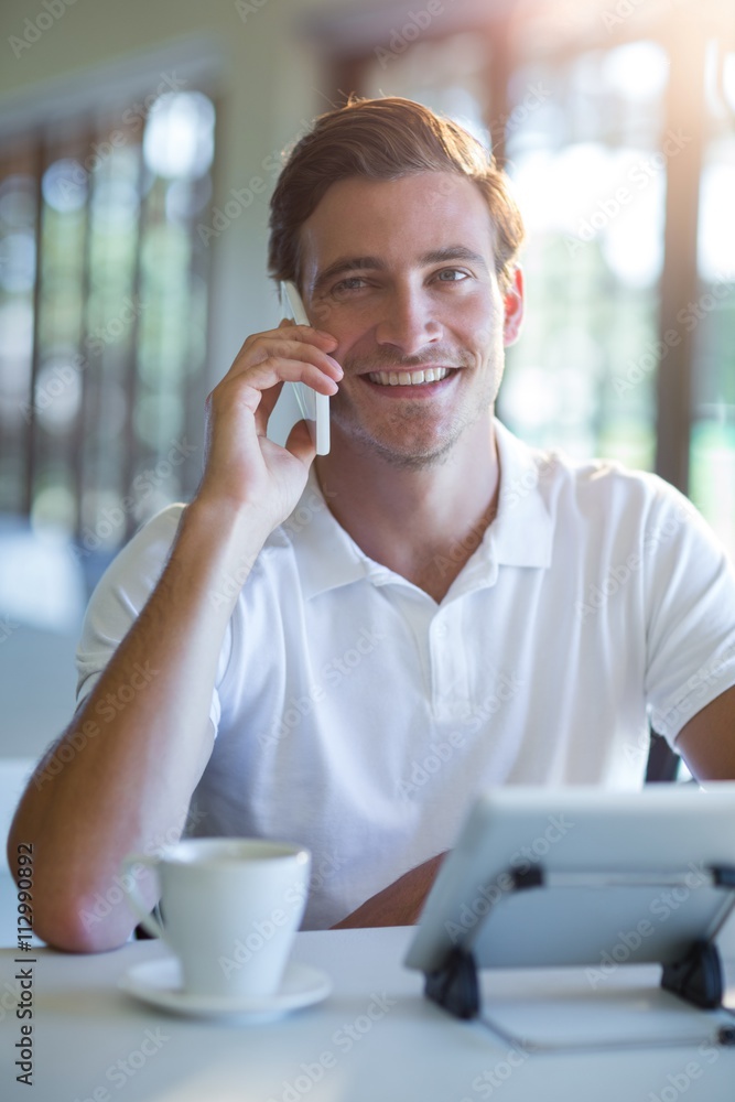 Poster smiling man talking on mobile phone