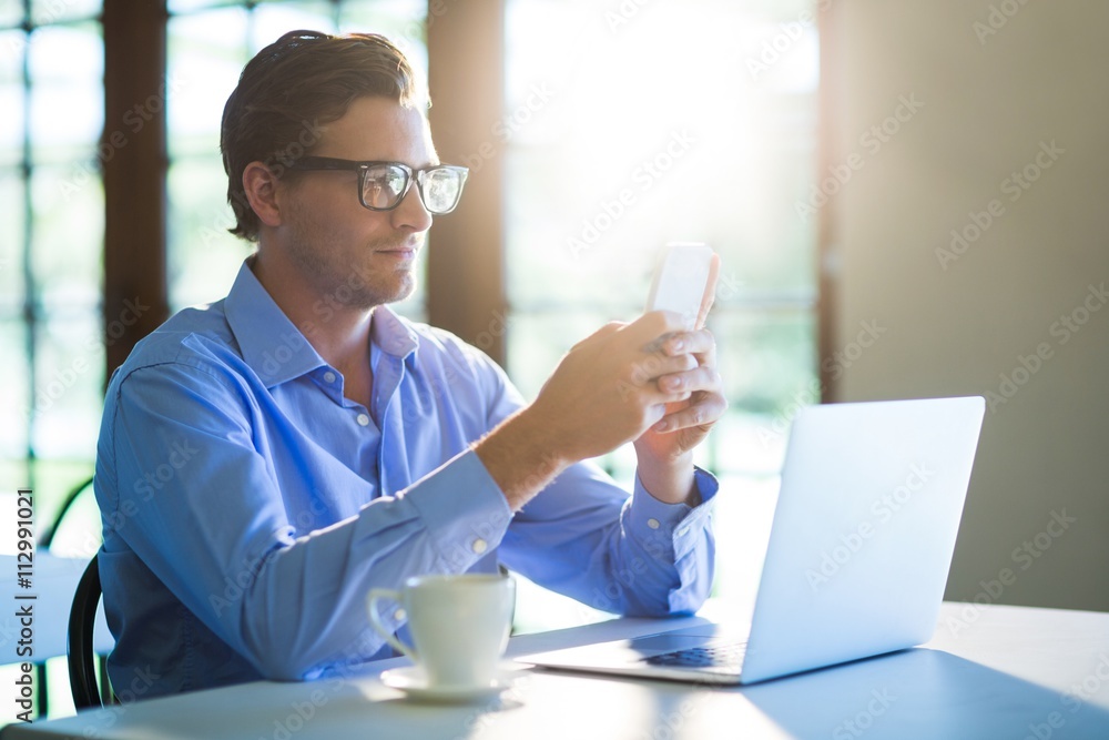 Poster man using a mobile phone in restaurant