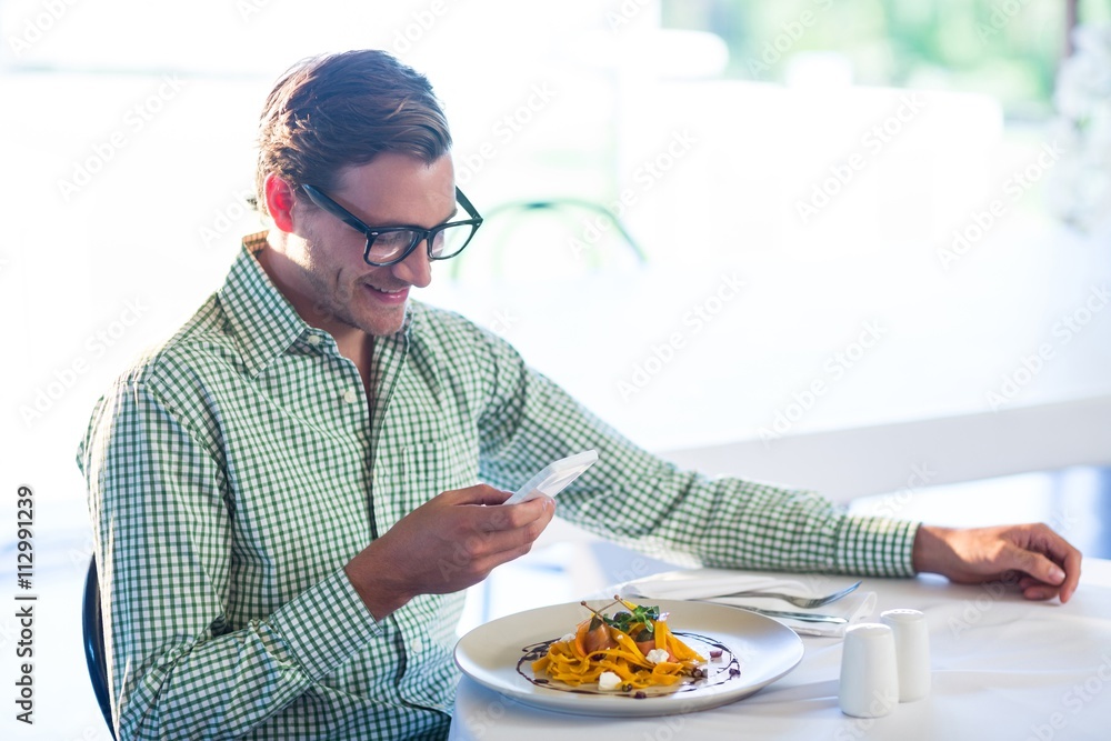 Poster Man using mobile phone while having a lunch