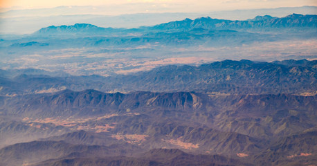 Aerial landscape view of mountain from window of airplane