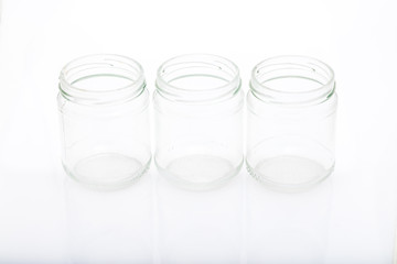 three little glass vases on a reflective surface