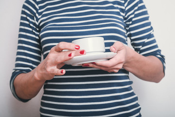 Cup of tea in hand with steam