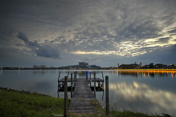 A wooden jetty at lake with sunset scenery in the background, Soft Focus due to Long Exposure Shot. shoot at Putrajaya, Malaysia.