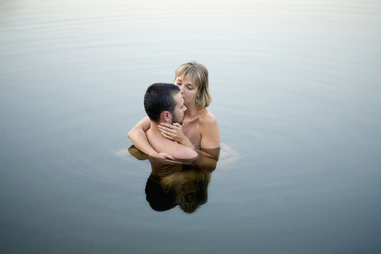 Couple embracing in water