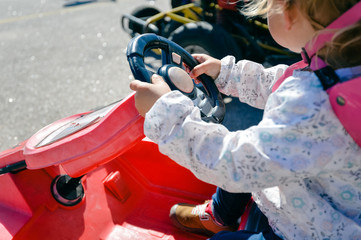 Obraz premium Small child riding a quad bike on sunny outdoors background