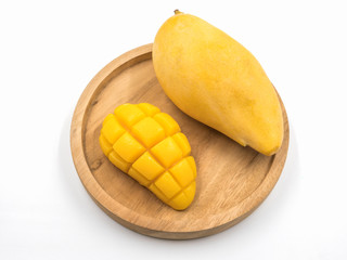Ripe mango on wooden tray.