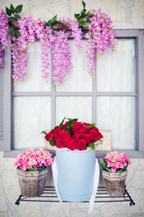 Image of beautiful and  colorful flowers in circular box and wooden pot