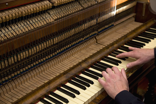 A man playing an organ, close up of hands
