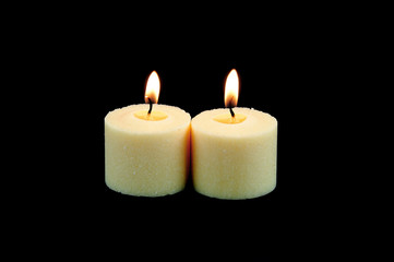Fototapeta na wymiar candle flame fire of white candle on black background