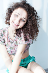 The girl with wavy curly hair smiling and rejoicing