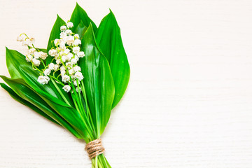 Bouquet of lilies of the valley on the light background. Spring