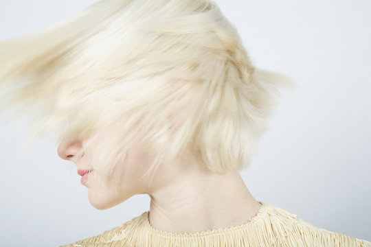 A young woman shaking her hair