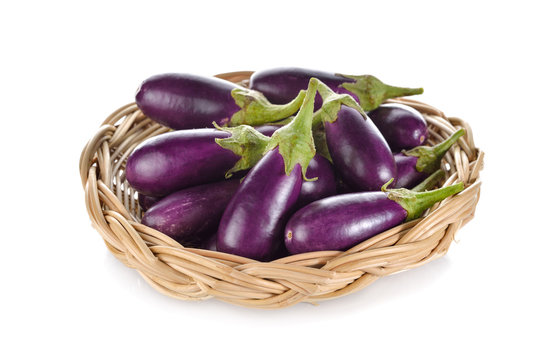 purple eggplant with stem in rattan basket on white background