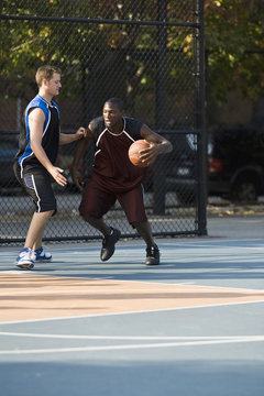 Two men playing basketball