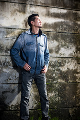 Asian young man wearing jeans clothes stand on the ground in fro