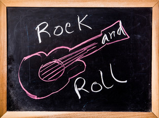 rock and roll word on blackboard