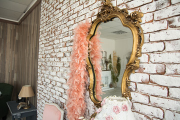 Mirror in golden curly frame against