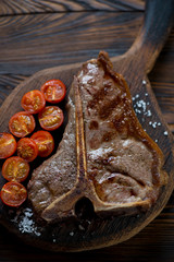 Top view of grilled marbled beef T-bone steak, close-up